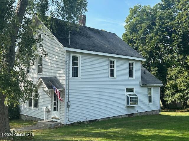 view of side of property with a yard