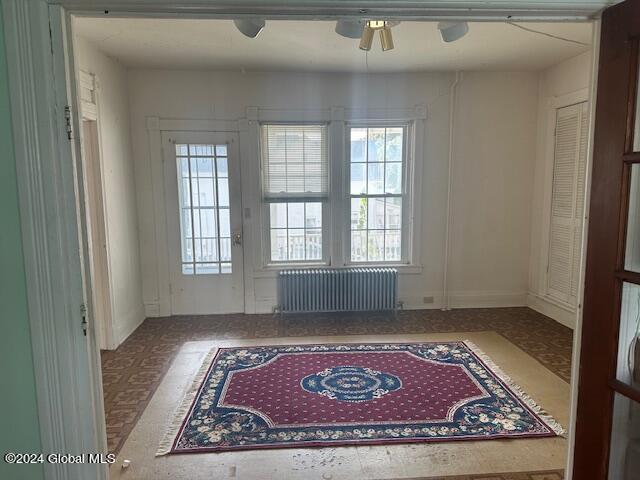 interior space featuring radiator and ceiling fan