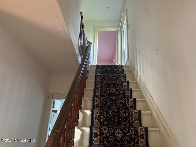 staircase featuring plenty of natural light