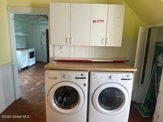 washroom featuring washer and clothes dryer and dark parquet flooring