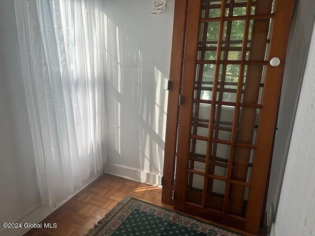 doorway to outside featuring parquet flooring