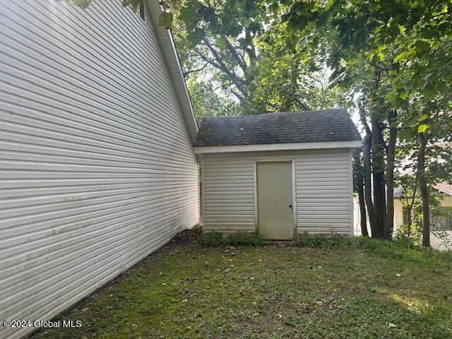 view of outdoor structure with a lawn