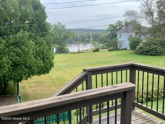 wooden deck featuring a yard and a water view