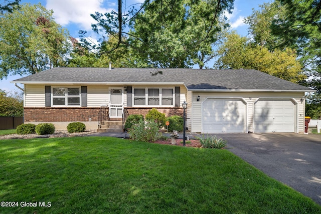 ranch-style home with a garage and a front lawn