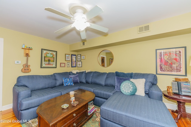 living room featuring ceiling fan and light hardwood / wood-style floors