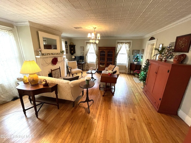 living room featuring a chandelier, light wood-type flooring, and ornamental molding