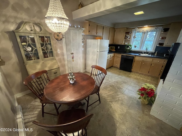 dining space with sink and an inviting chandelier