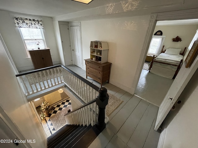 staircase with hardwood / wood-style flooring