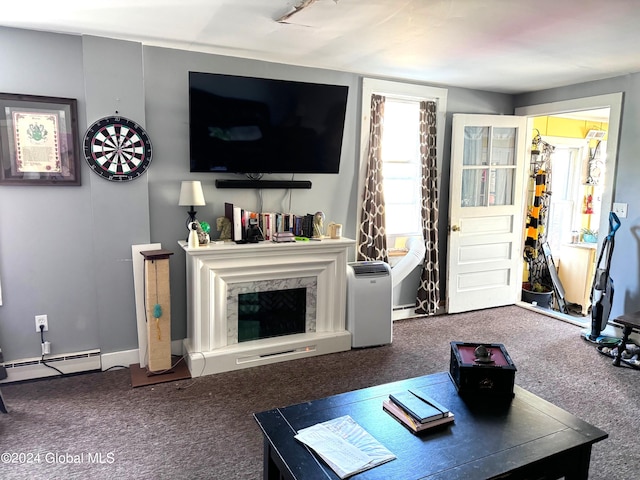 living room with baseboard heating, a premium fireplace, and carpet