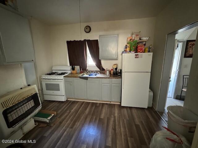 kitchen featuring white appliances, dark wood-style floors, white cabinetry, heating unit, and a sink