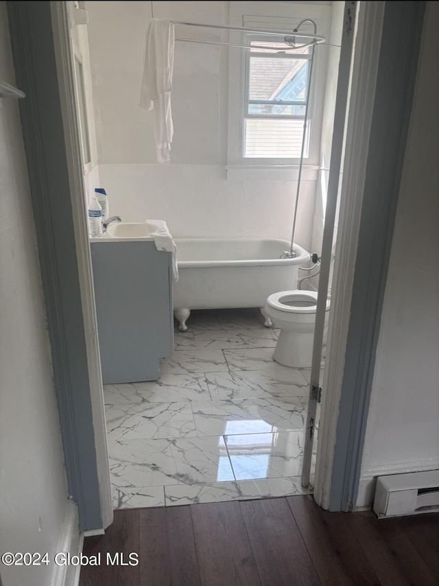 bathroom featuring vanity, baseboard heating, a bathing tub, toilet, and marble finish floor