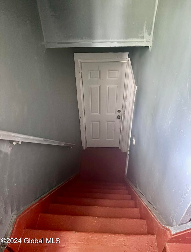 stairway featuring wood-type flooring