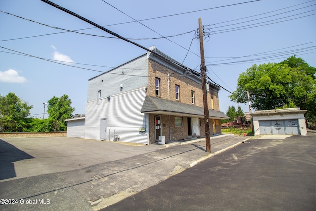 view of front facade with a garage and an outbuilding