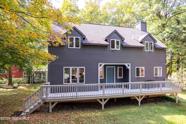 back of house featuring a deck and a lawn