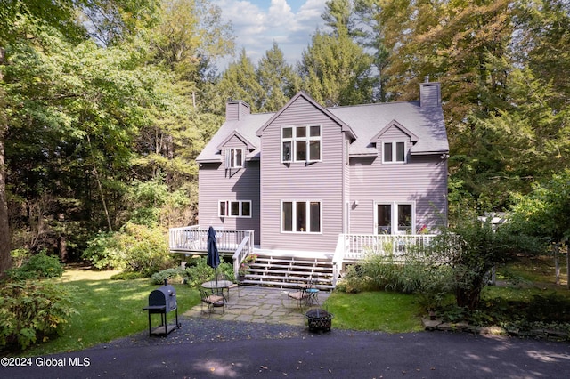 exterior space featuring a deck, a yard, and a patio area