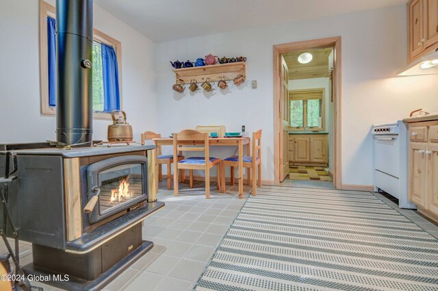 office featuring sink, a wood stove, and a wealth of natural light