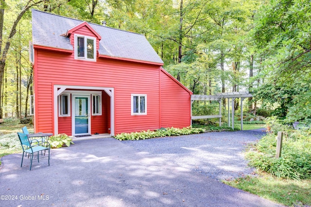 view of side of property with a pergola and a patio