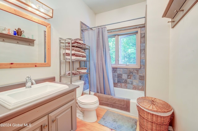 full bathroom featuring shower / tub combo with curtain, vanity, and toilet