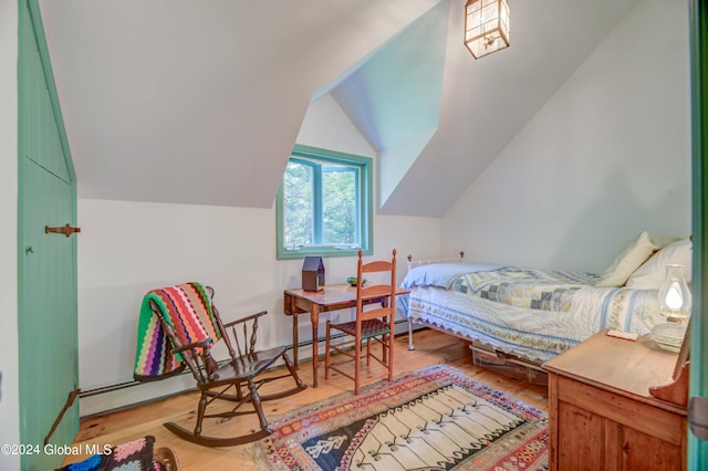 bedroom with light hardwood / wood-style floors and vaulted ceiling