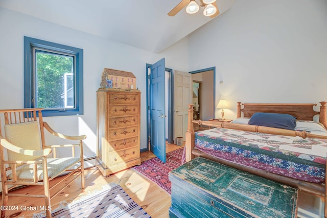 bedroom with vaulted ceiling, ceiling fan, and hardwood / wood-style flooring