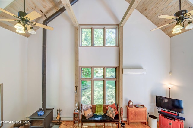 living room with ceiling fan, hardwood / wood-style flooring, wood ceiling, and plenty of natural light