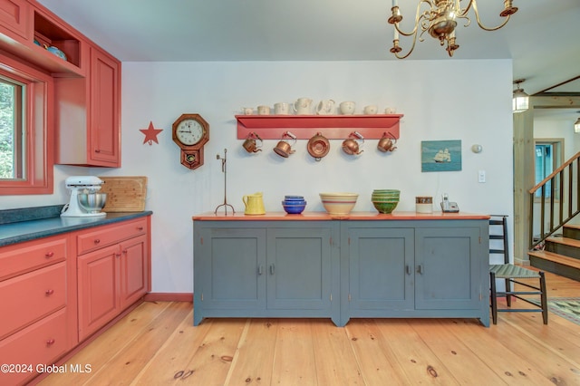 kitchen with an inviting chandelier and light hardwood / wood-style flooring