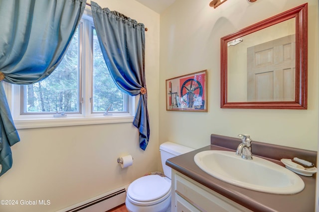 bathroom featuring a baseboard heating unit, vanity, and toilet