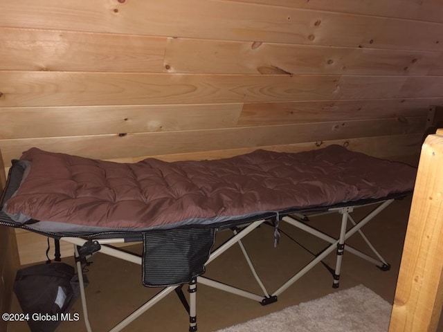 bedroom featuring wood walls