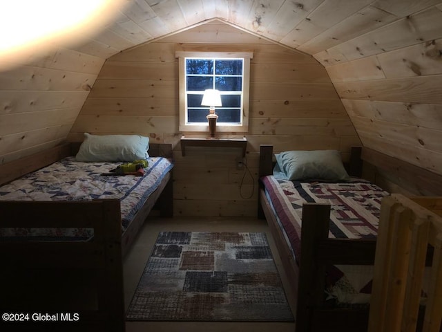 bedroom featuring lofted ceiling and wooden walls