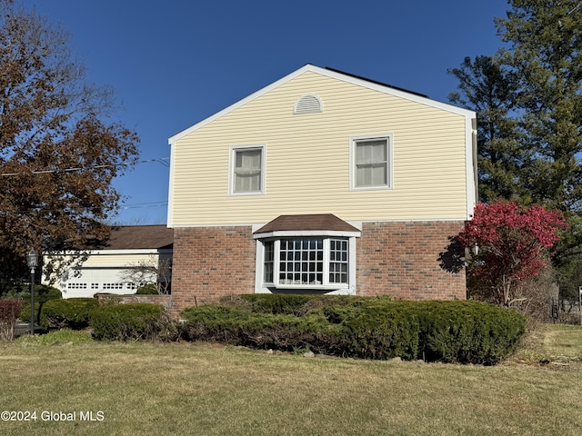 25 Kling Ter, Voorheesville, NY 12186 - view of side of home featuring brick siding, a lawn, and a shingled roof