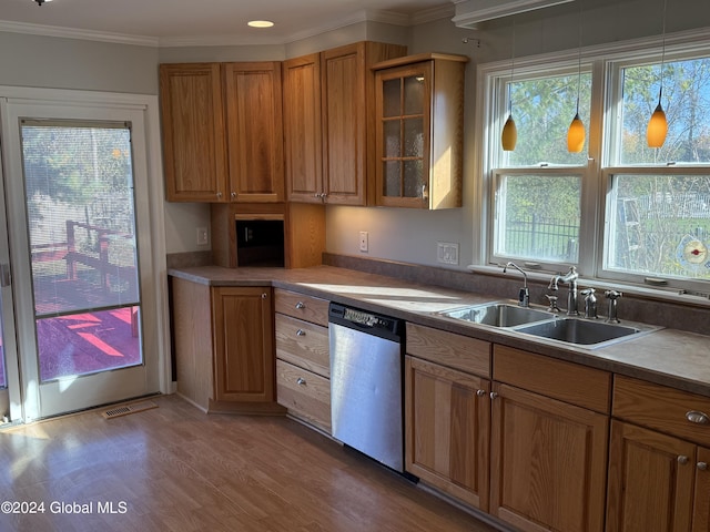 25 Kling Ter, Voorheesville, NY 12186 - kitchen featuring stainless steel dishwasher, a sink, brown cabinets, light wood finished floors, and glass insert cabinets