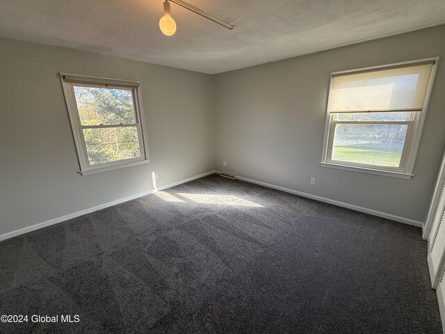 25 Kling Ter, Voorheesville, NY 12186 - spare room featuring a textured ceiling, carpet, and baseboards