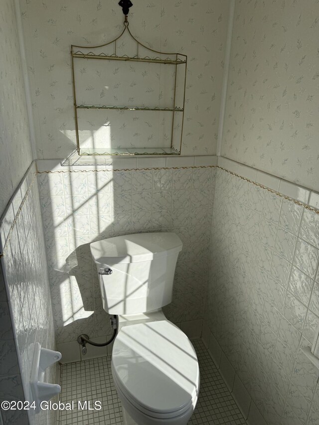 25 Kling Ter, Voorheesville, NY 12186 - half bathroom featuring wallpapered walls, tile patterned flooring, toilet, wainscoting, and tile walls