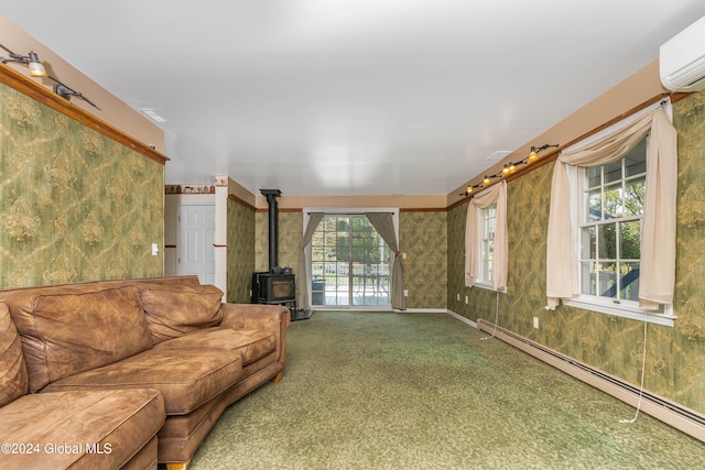 carpeted living room with baseboard heating, a wood stove, a wall unit AC, and a healthy amount of sunlight