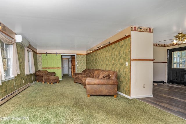 living room with carpet flooring, a wall unit AC, ceiling fan, a baseboard heating unit, and a barn door