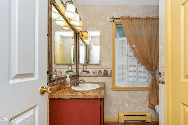 bathroom featuring vanity, a baseboard radiator, and toilet