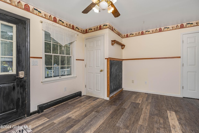 unfurnished room with ceiling fan, a baseboard radiator, and dark hardwood / wood-style floors