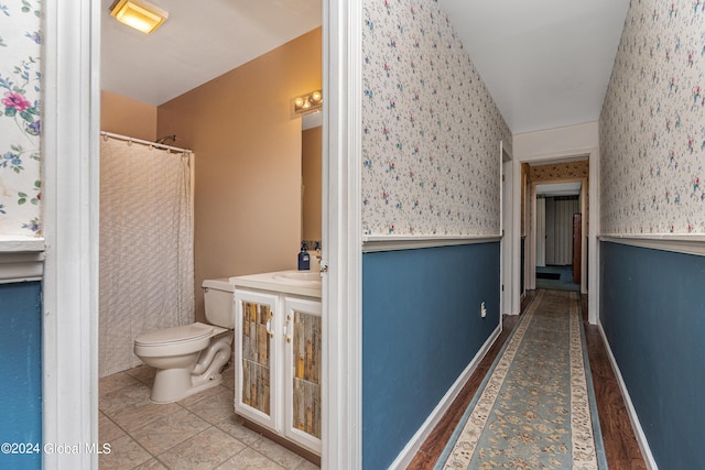 bathroom with tile patterned floors, vanity, and toilet