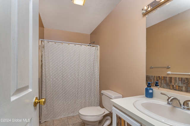 bathroom with tile patterned flooring, vanity, and toilet