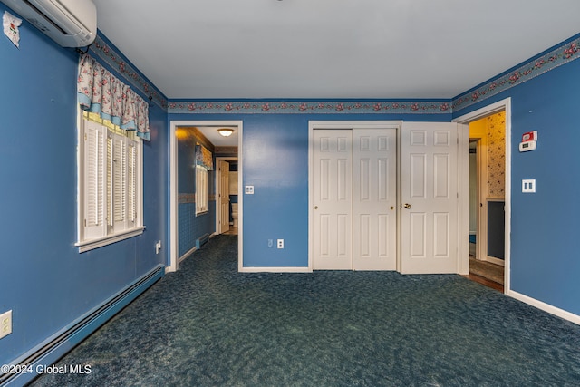 unfurnished bedroom with dark carpet, a baseboard radiator, an AC wall unit, and a closet