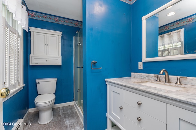 bathroom featuring a baseboard radiator, hardwood / wood-style floors, toilet, vanity, and a shower with shower door