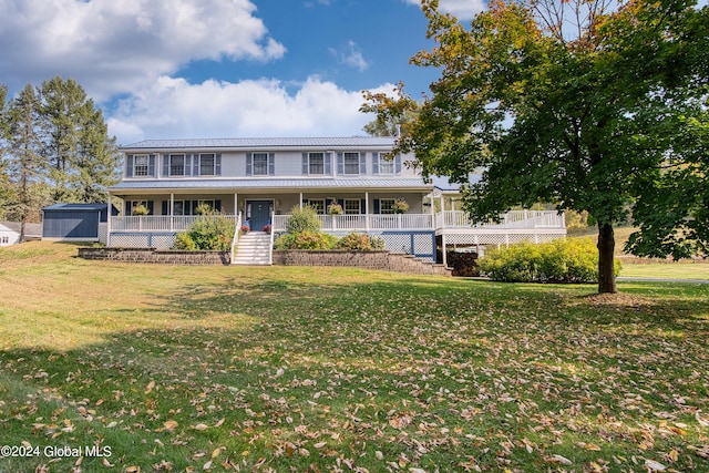 view of front of property featuring covered porch and a front lawn