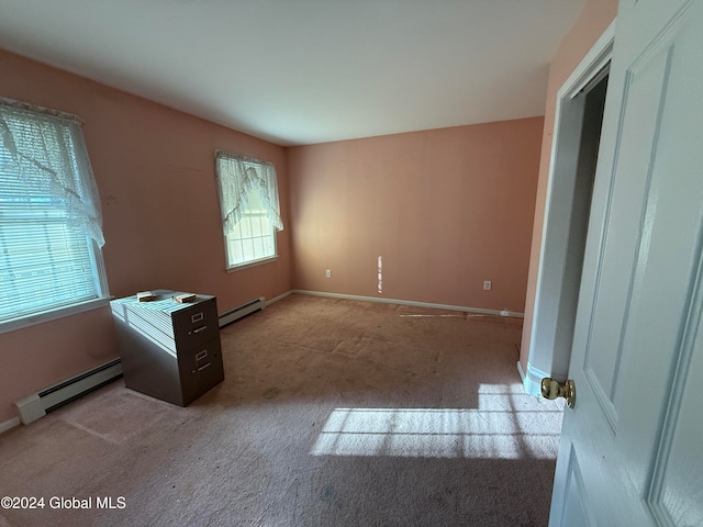 carpeted spare room featuring a baseboard radiator