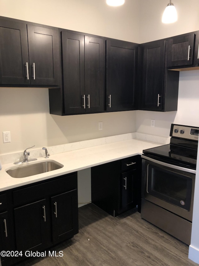 kitchen featuring hardwood / wood-style floors, sink, and stainless steel electric range