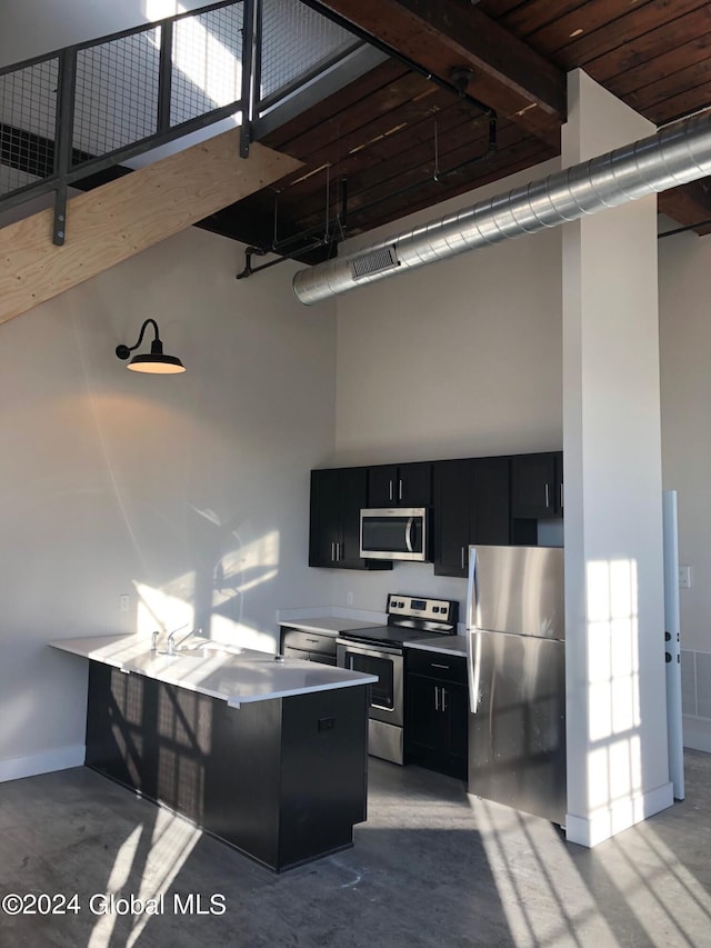 kitchen featuring a breakfast bar, kitchen peninsula, stainless steel appliances, a high ceiling, and wooden ceiling