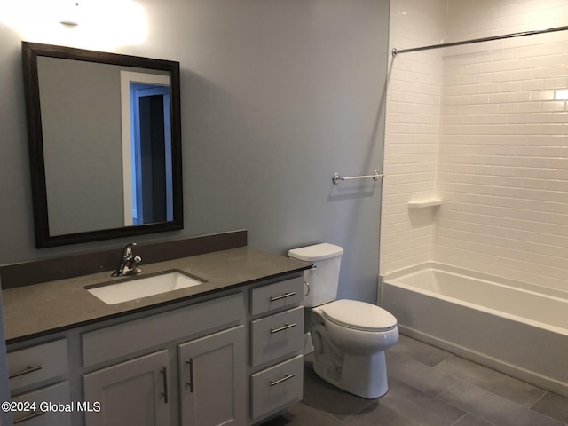 full bathroom with tiled shower / bath combo, tile patterned flooring, vanity, and toilet