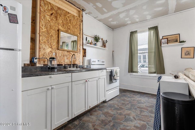 kitchen featuring white appliances, white cabinetry, and sink