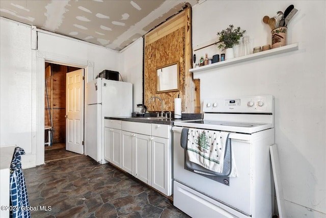 kitchen with white appliances, white cabinetry, and sink