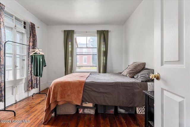 bedroom with dark hardwood / wood-style floors