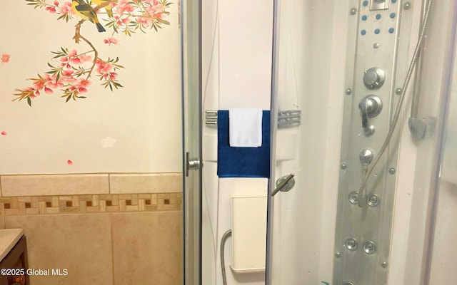 full bath featuring a shower with door and vanity